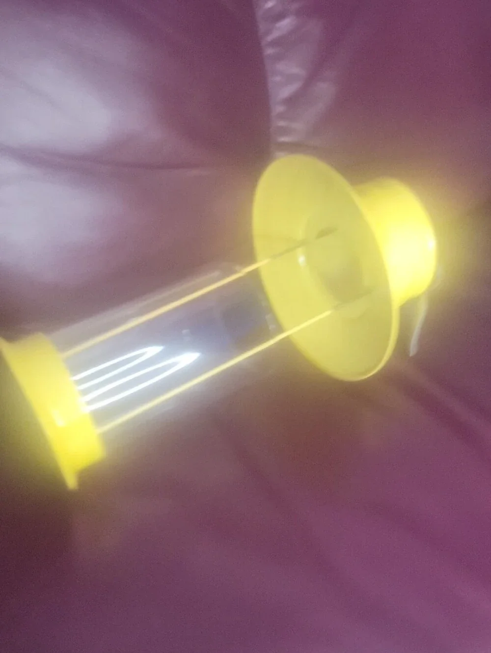 bright yellow metal and glass tealight candle holder labeled 